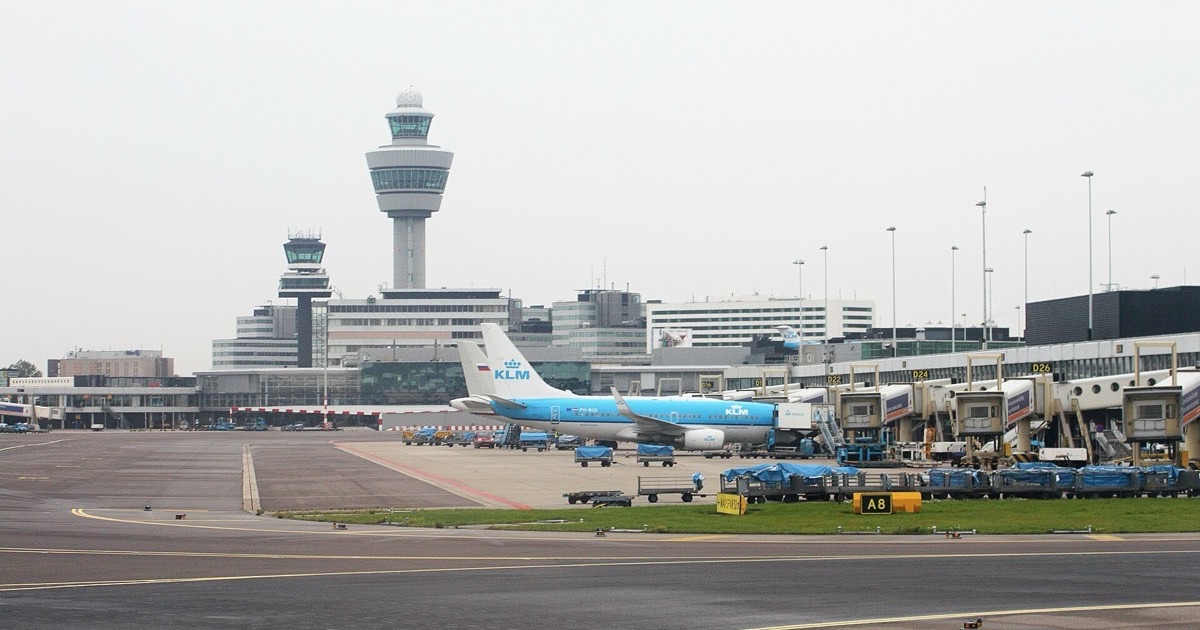 A KLM aircraft and the control tower at Amsterdam Airport Schiphol