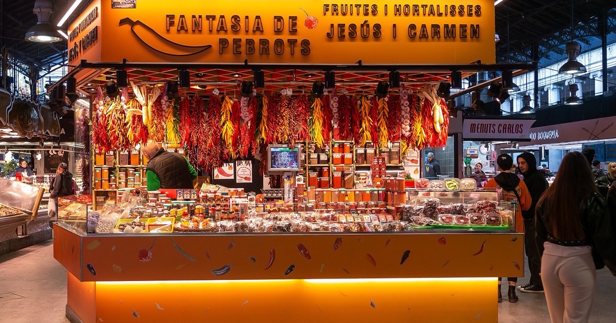 A colourful produce and spice stall at La Boqueria market in Barcelona