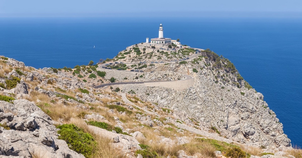 The lighthouse and winding road at Cap de Formentor, Mallorca, above a blue sea